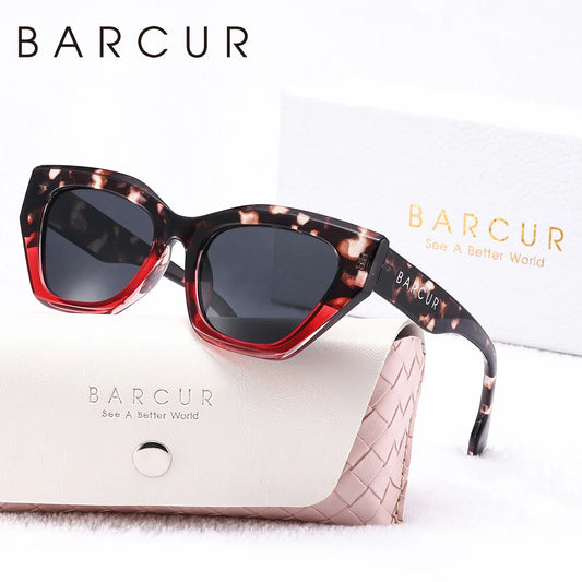Sunglasses with a leopard print frame and dark lenses, placed on a white surface with 'BARCUR' branding.