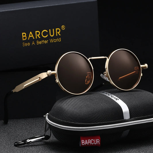 Round sunglasses with gold frame and brown lenses on a black surface with BARCUR branding.