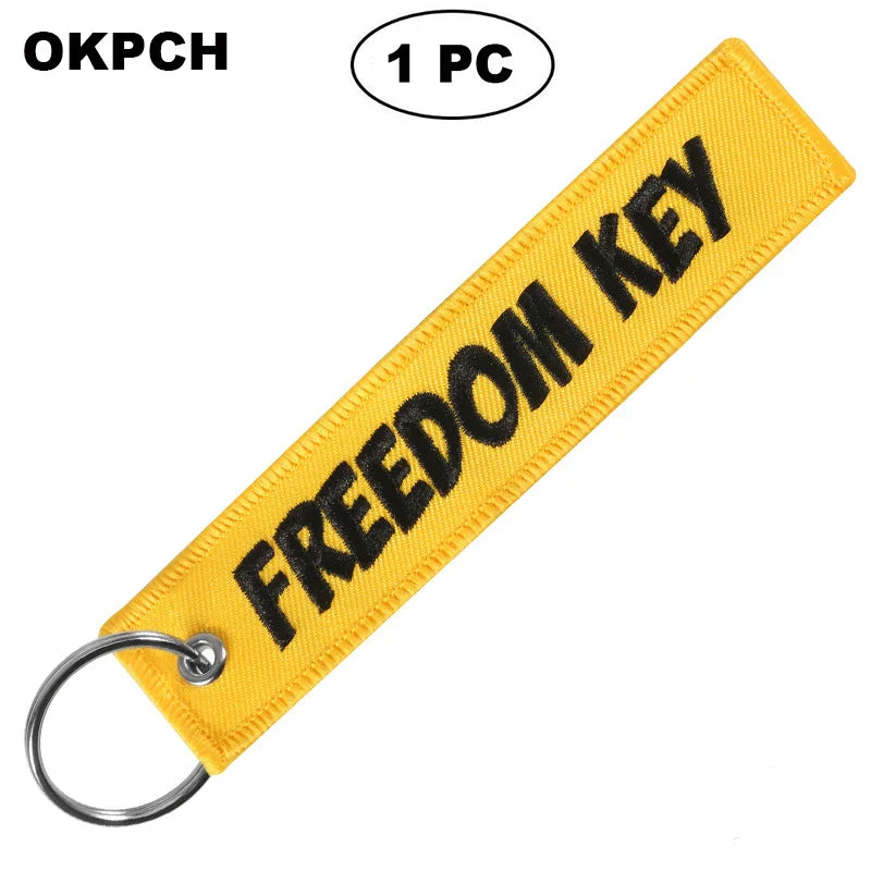 Yellow keychain with 'FREEDOM KEY' text on a white background
