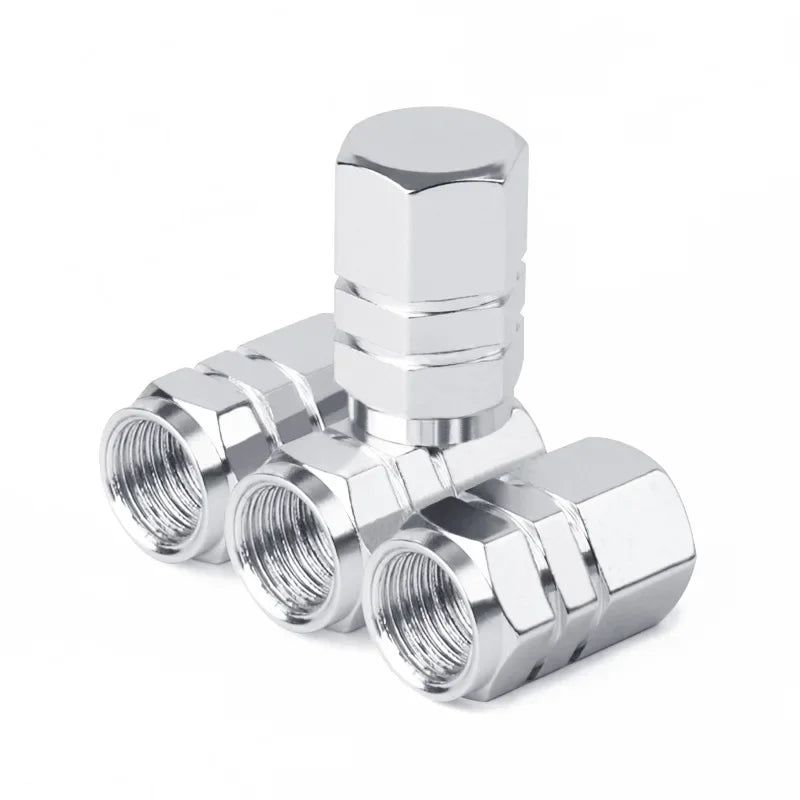 Silver metal valve stem caps on a white background