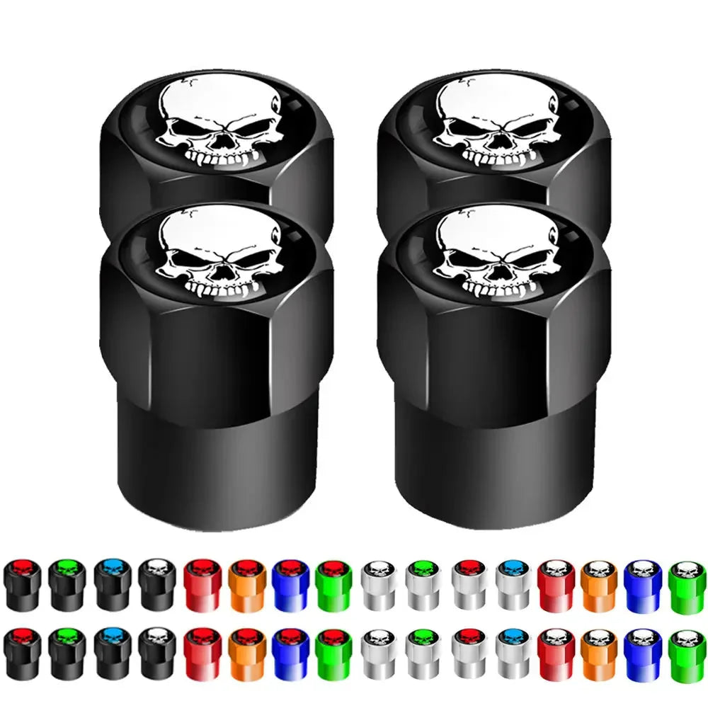 Four black skull-shaped valve stem caps with additional colorful options displayed below on a white background.