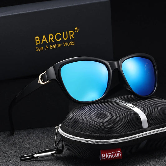 Sunglasses with blue lenses and black frame on a dark surface with BARCUR branding.