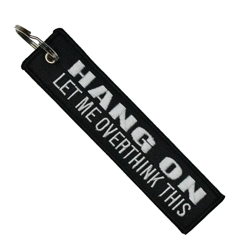 Black keychain with white text on a white background