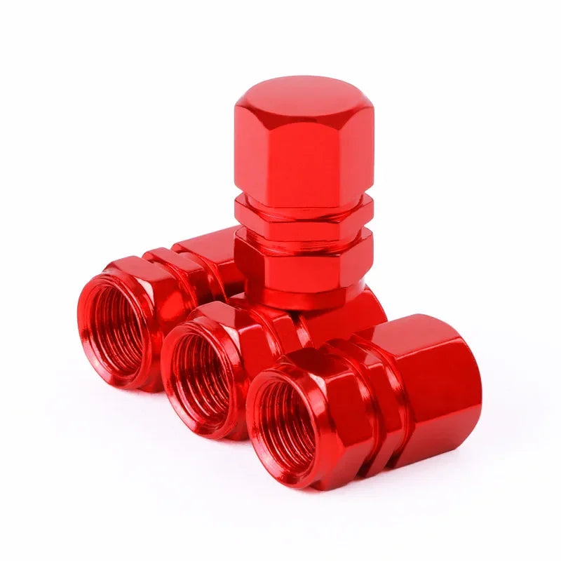 Red metal valve stem caps on a white background