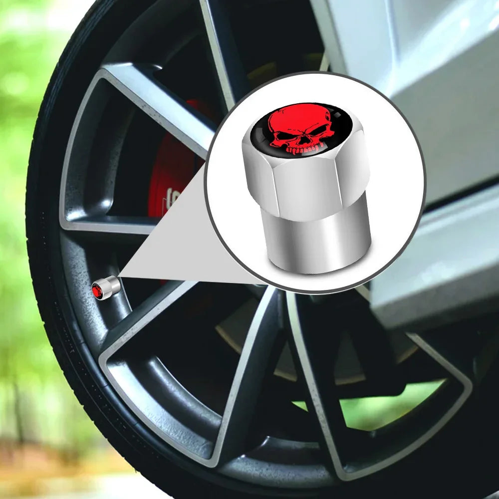 Car wheel with a red skull valve stem cap on a blurred background