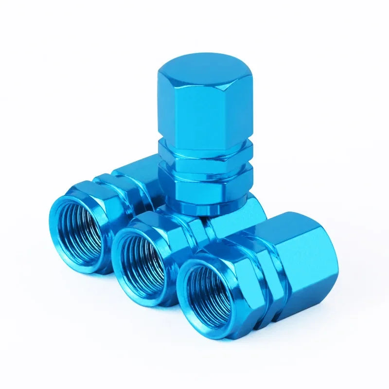 Blue metal valve stem caps on a white background