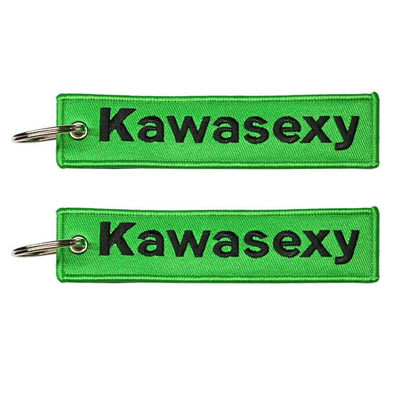 Two green keychains with 'Kawasexy' text on a white background