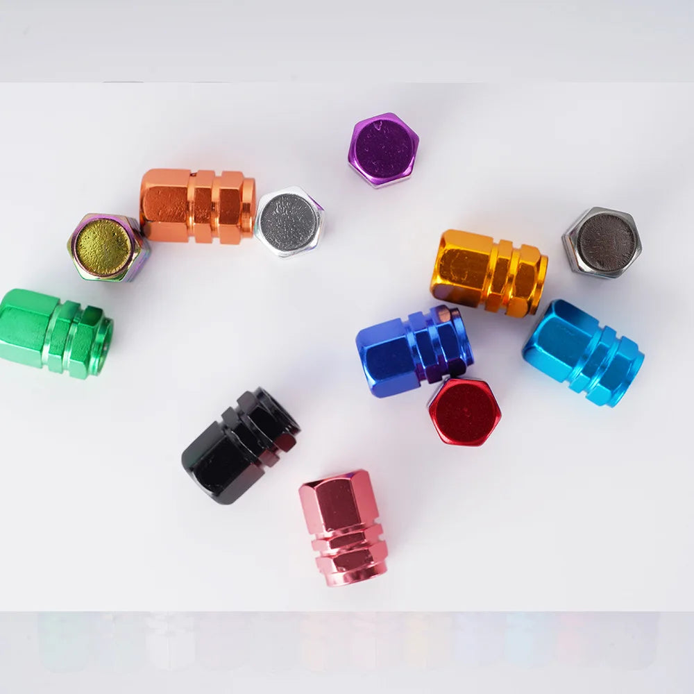 Colorful metal valve stem caps on a white background