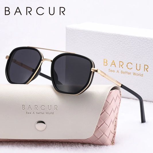 Sunglasses with gold frame and black lenses on a BARCUR branded case.