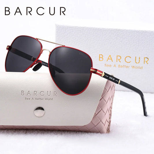 Sunglasses with red and black frame and dark lenses on a BARCUR branded case.
