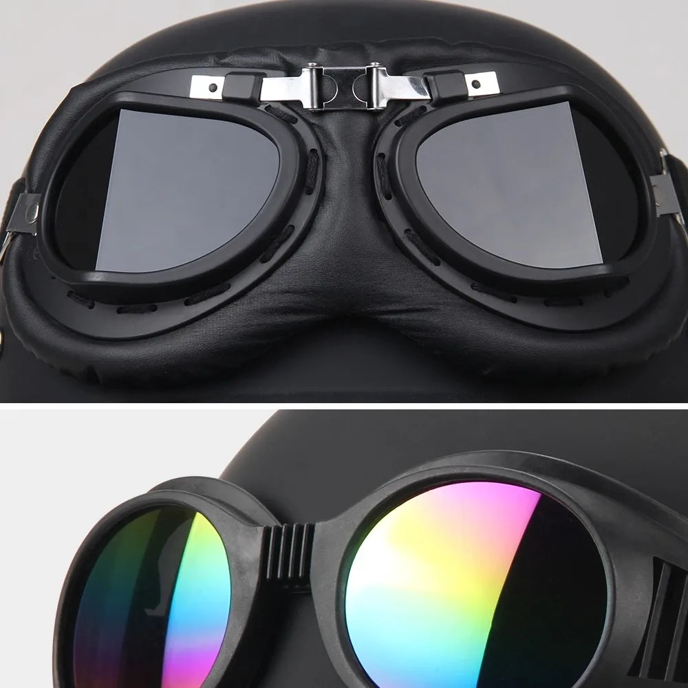 Close-up of a black helmet with goggles featuring reflective lenses on a gray background.