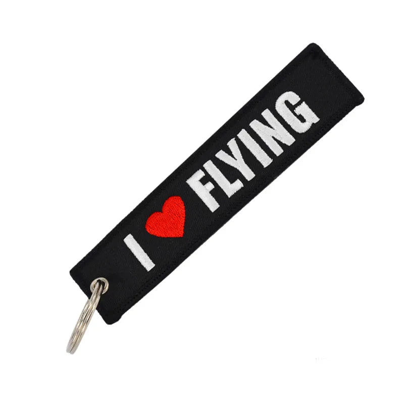 Black keychain with 'I ❤️ FLYING' text on a white background