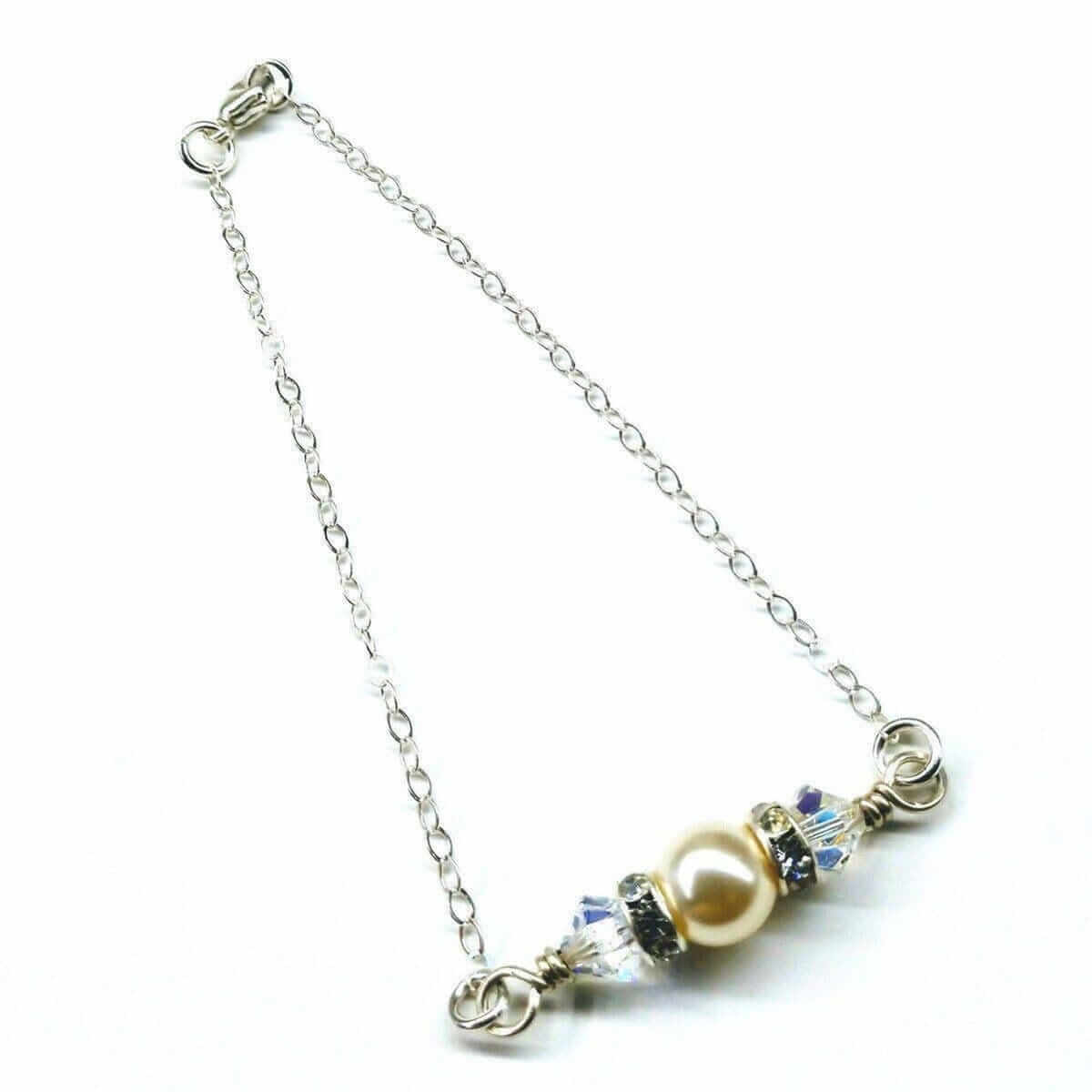 Necklace with a pearl and crystal pendant on a white background