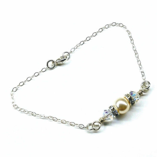 Bracelet with pearls and crystals on a white background