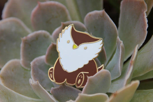 Enamel pin of a cartoon character on a succulent plant