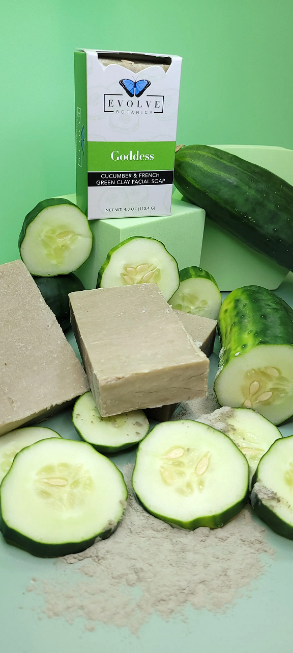 Cucumber slices, soap bars, and a box labeled 'Goldness' on a green background