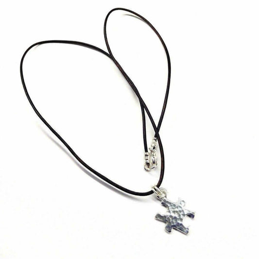 Necklace with an autism pendant on a white background