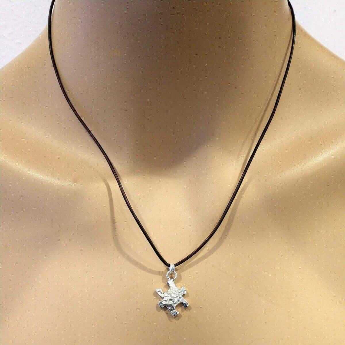Necklace with an autism pendant on a mannequin