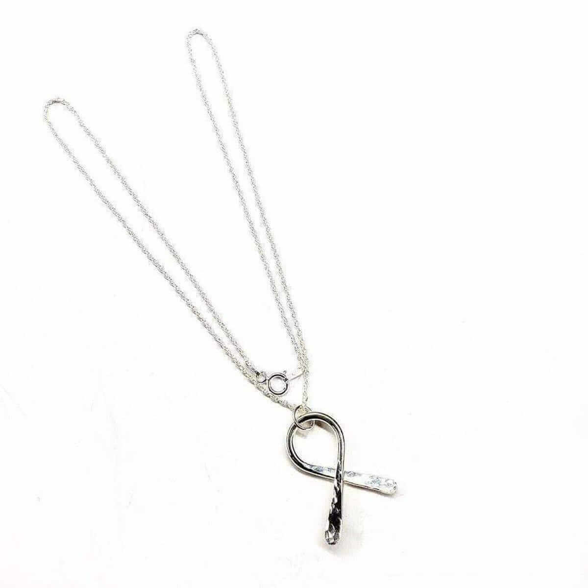 Silver necklace with an autism pendant on a white background