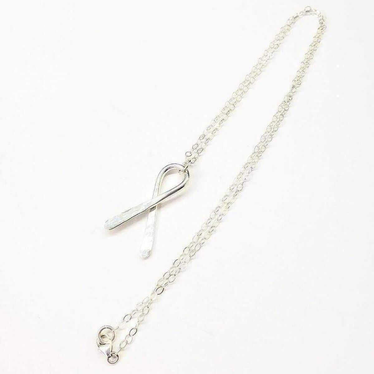 Silver necklace with a heart-shaped clasp on a white background