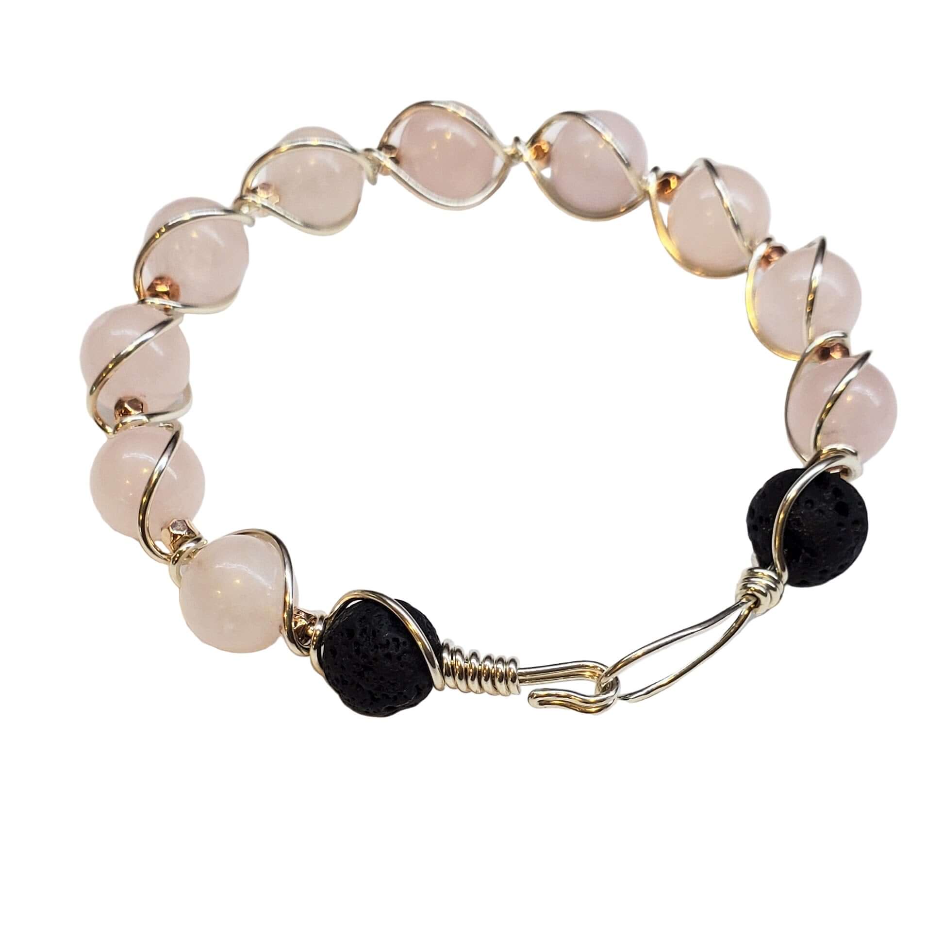 Bracelet with pink beads and black stones on a white background