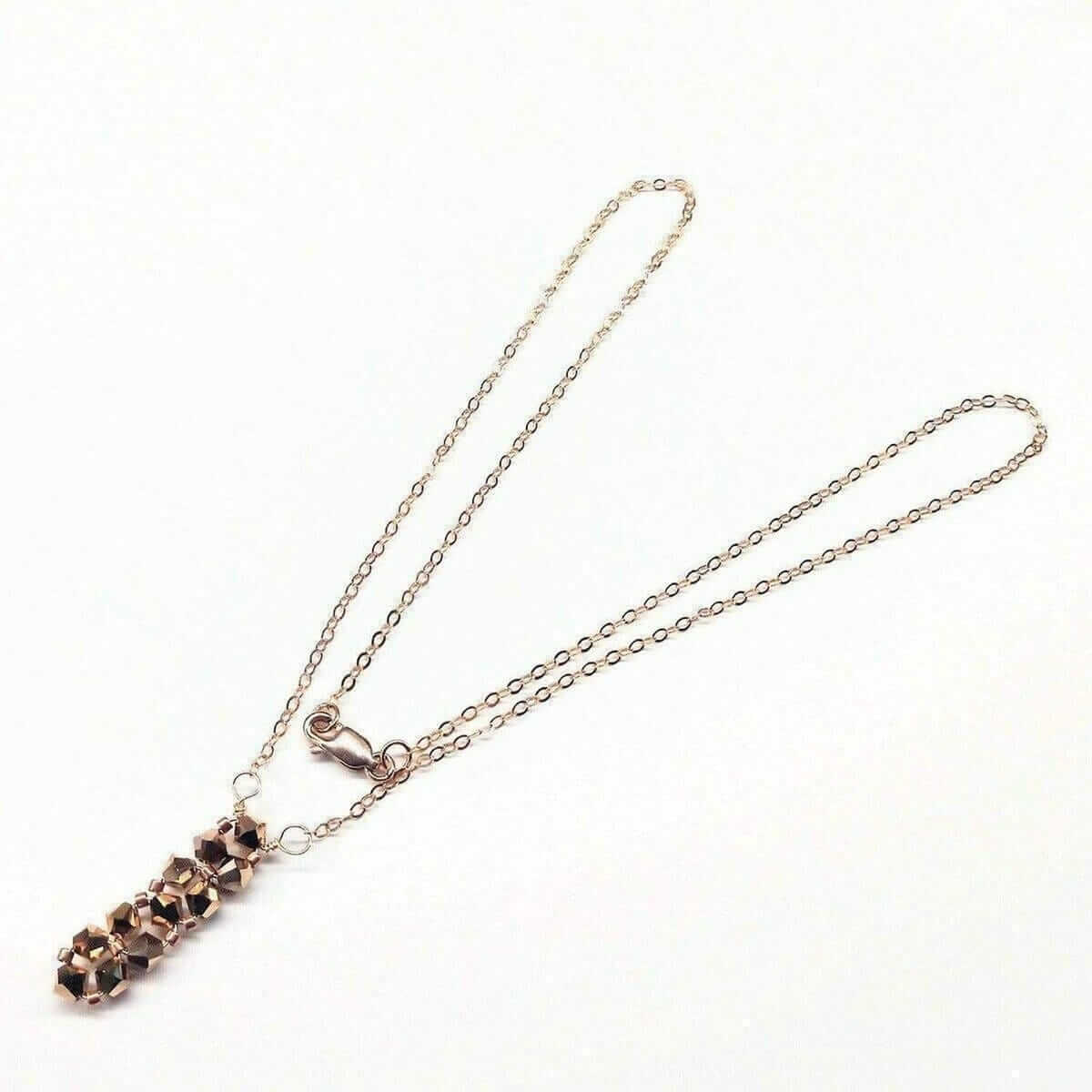 Necklace with a rose gold pendant on a white background