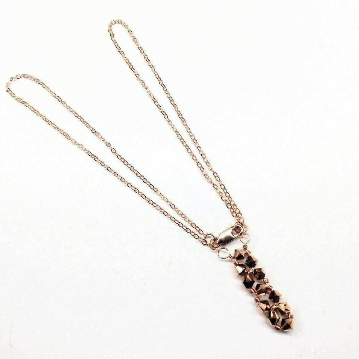 Necklace with a rose gold chain and pendant on a white background