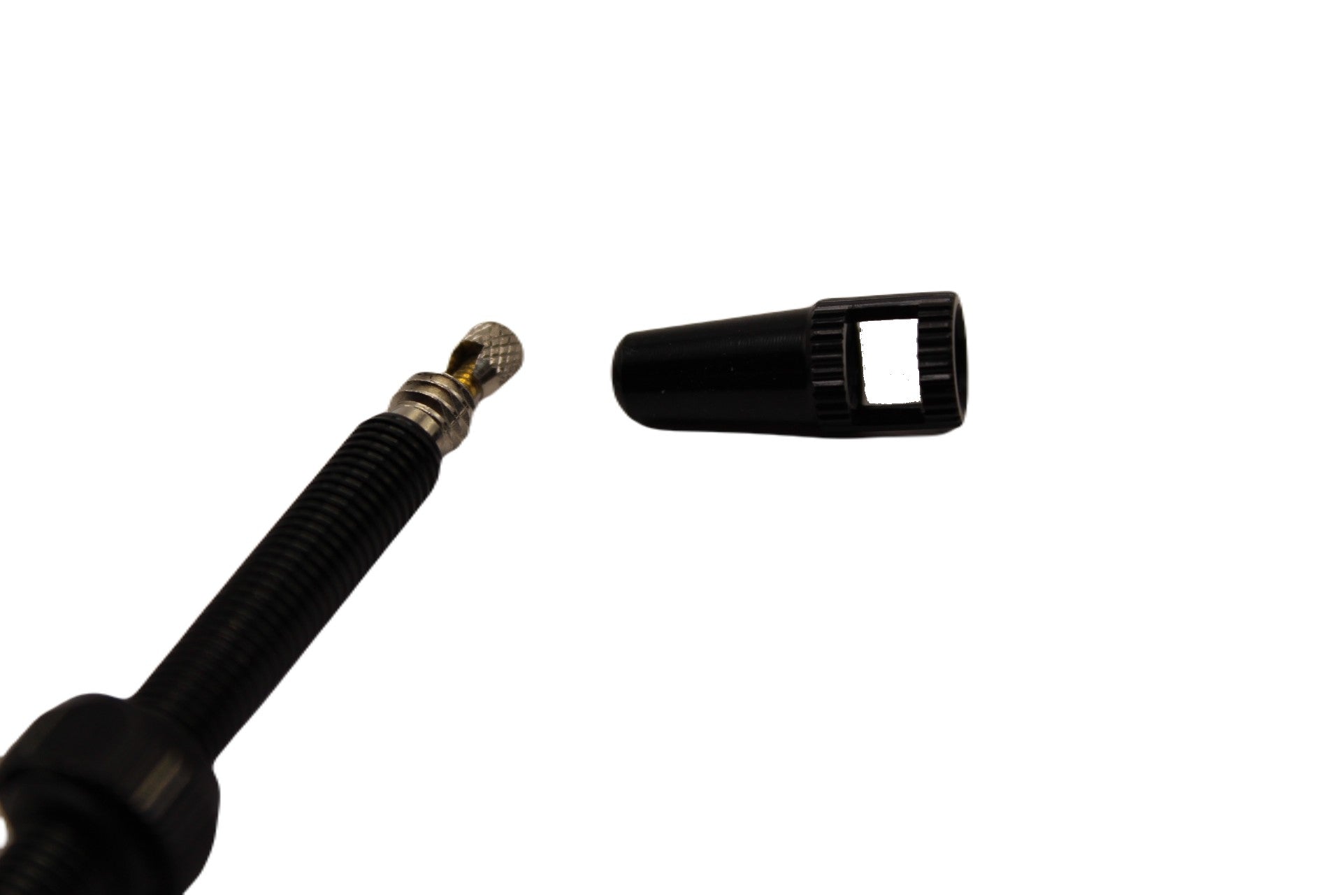 Black valve stem and cap on a white background