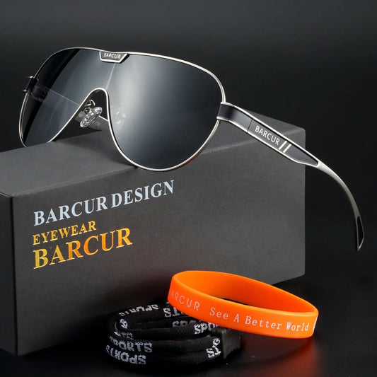 Barcur sunglasses with a black box and orange wristband on a dark background