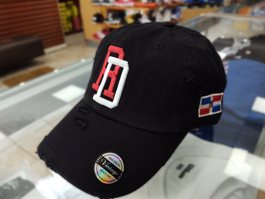 Black cap with DR {Dominican Republican} logos on a glass surface