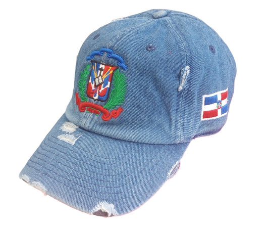Blue denim cap with embroidered Dominican design on a white background