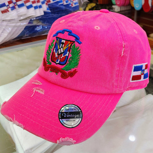 Pink cap with a colorful Dominican Republic emblem and 'Katinion Vintage' label on a white surface.