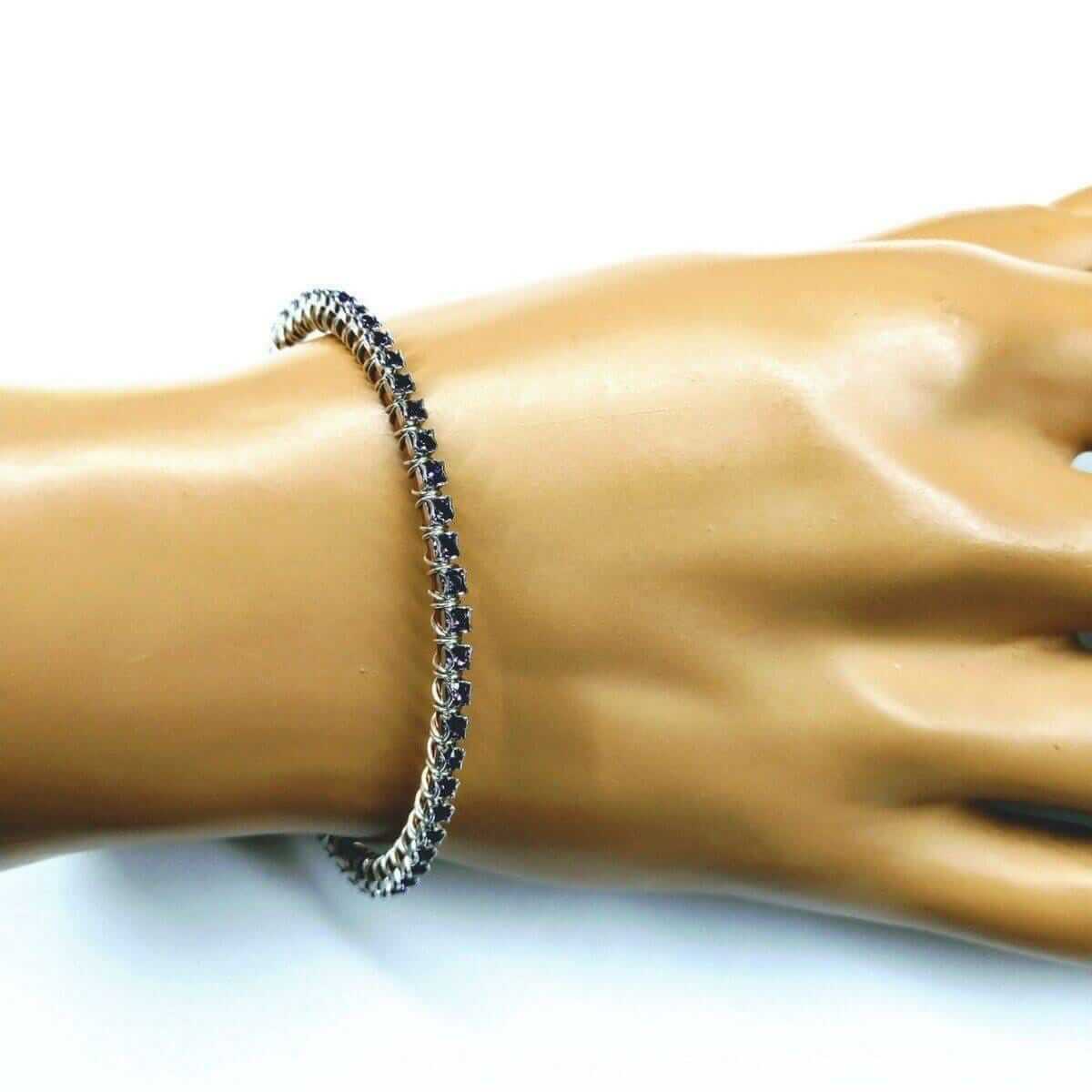 Bracelet on a mannequin wrist with a white background