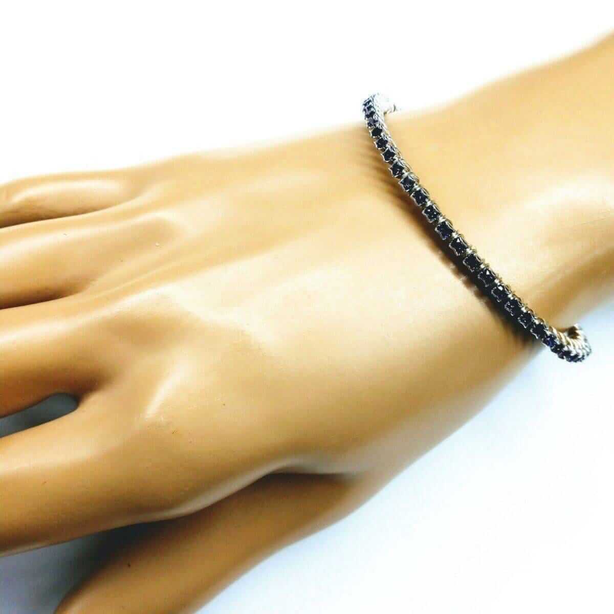 Black beaded bracelet on a mannequin wrist with a white background