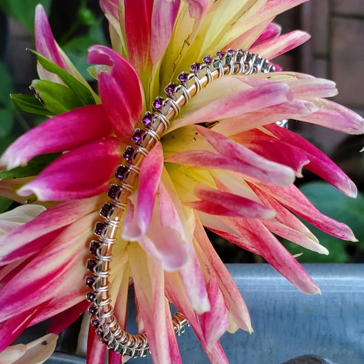 Bracelet with purple beads on a pink and yellow flower