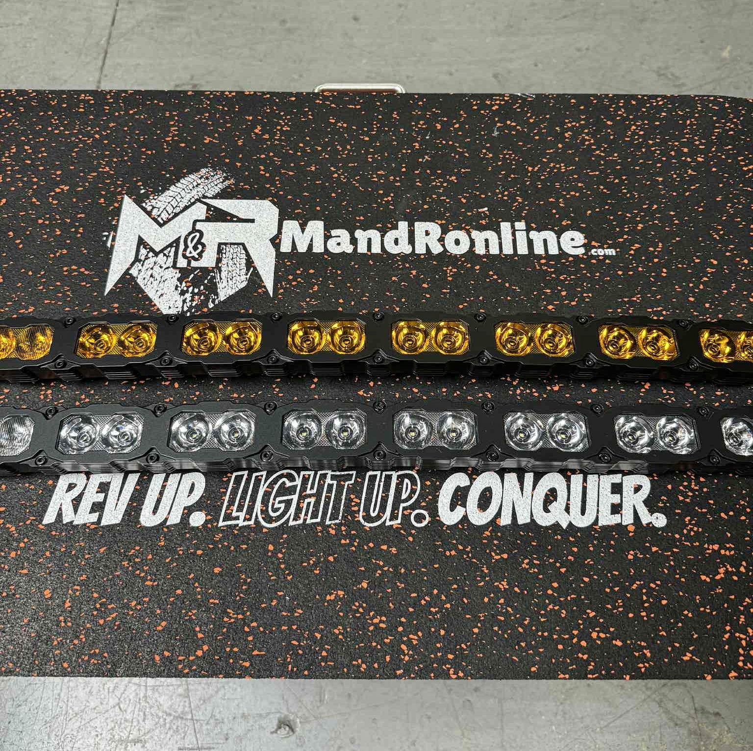 MandRonline LED light bar with text 'Rev Up. Light Up. Conquer.' on a speckled surface.