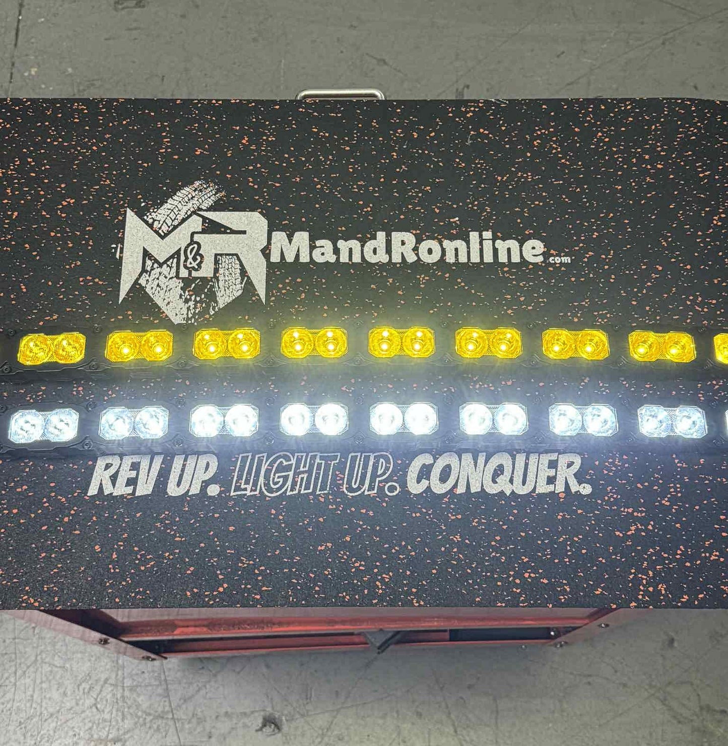 Light-up sign with 'MandR online' branding and motivational text on a dark background.