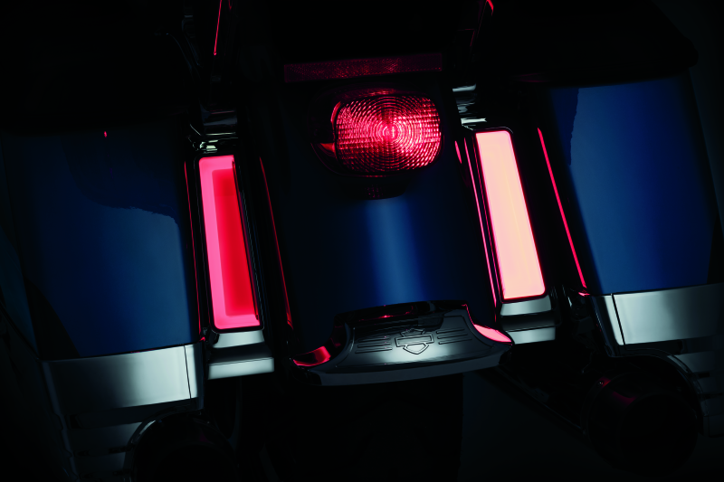 Close-up of motorcycle red tail lights in a dark setting