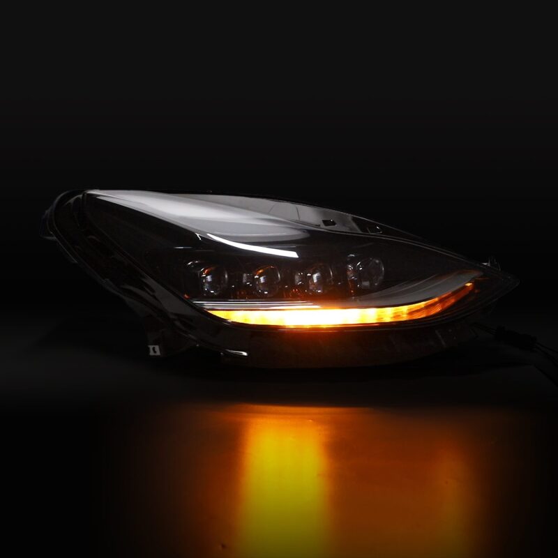 Car headlight with amber turn signal on a black background