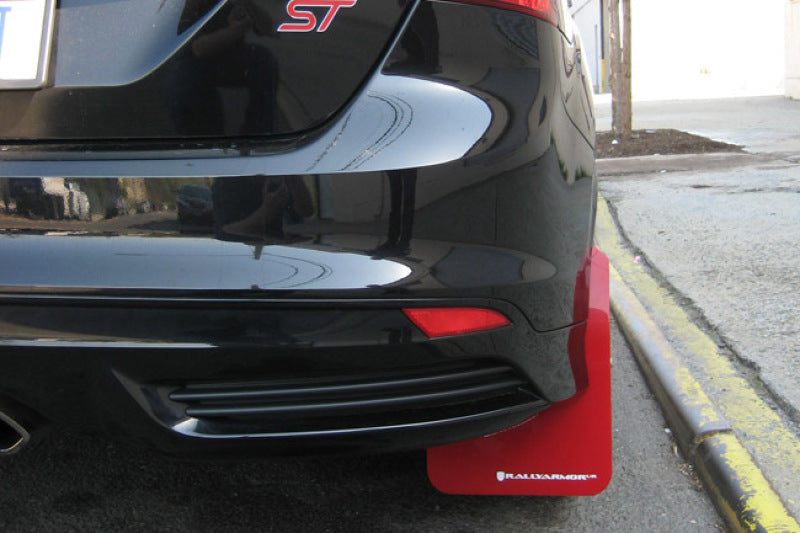 Black car with a red undercarriage guard on a street