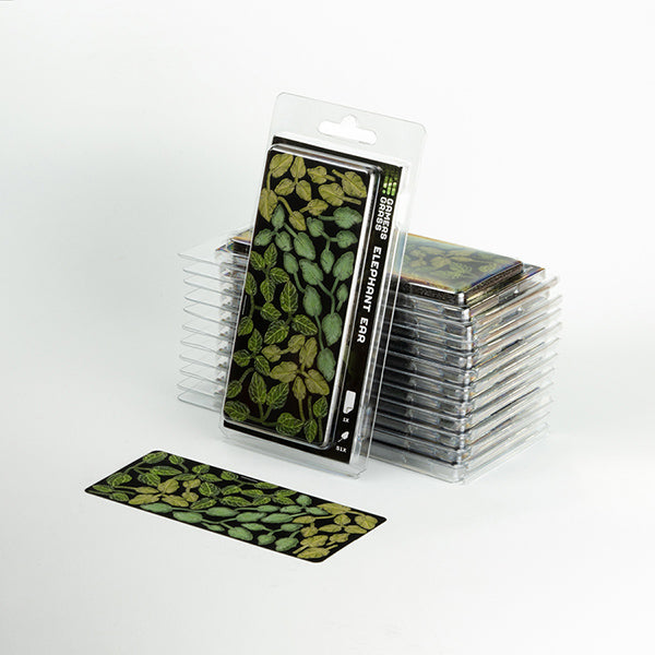 Stack of miniature artificial plants with green leaf design on a white background
