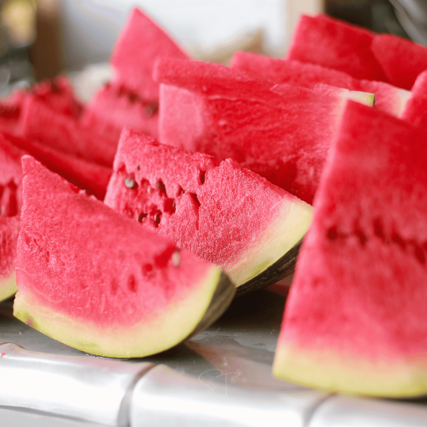 Slices of watermelon on a white surface