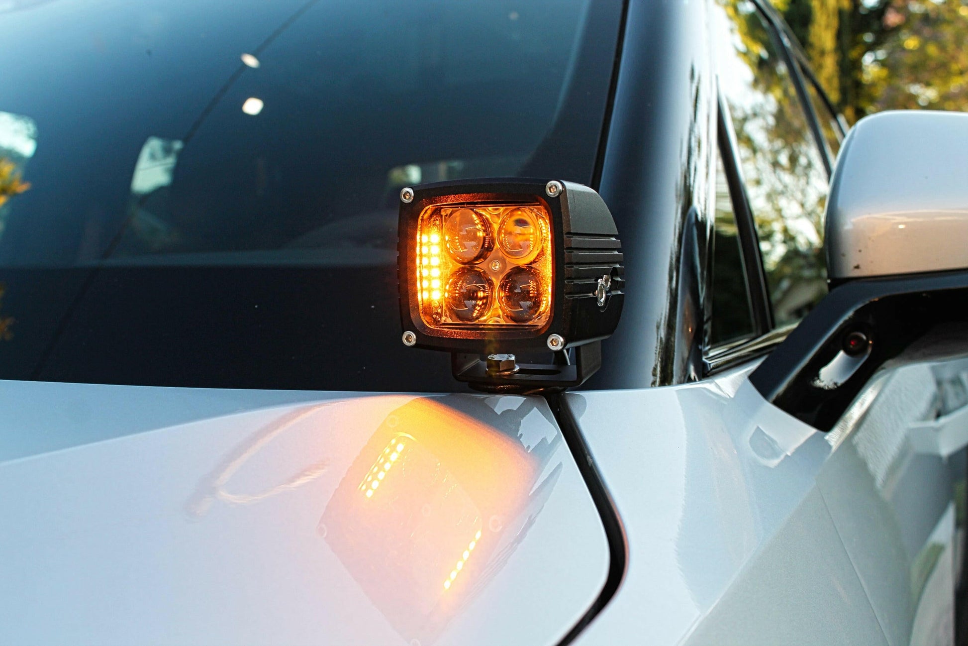 Car side mirror with an amber LED light on a Rivian vehicle