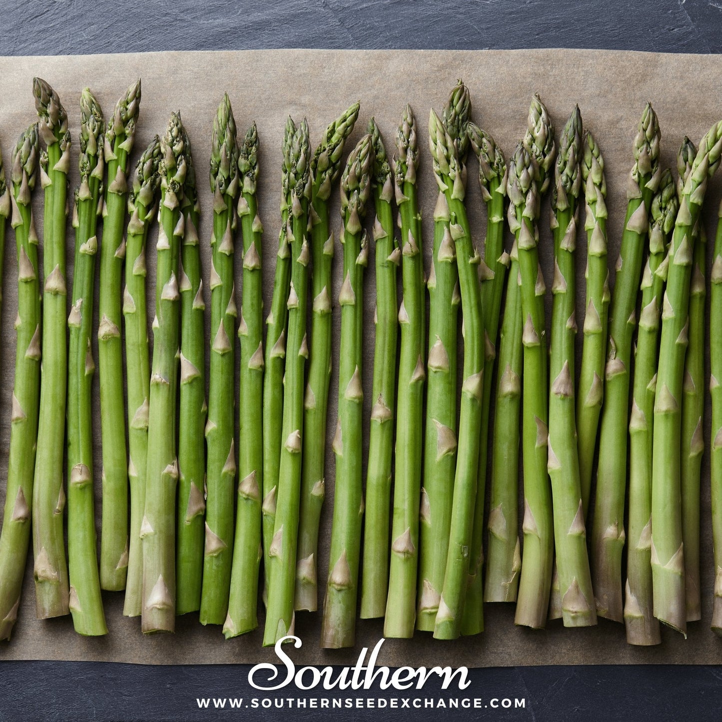 Green asparagus spears arranged on a baking sheet with 'Southern' brand visible.