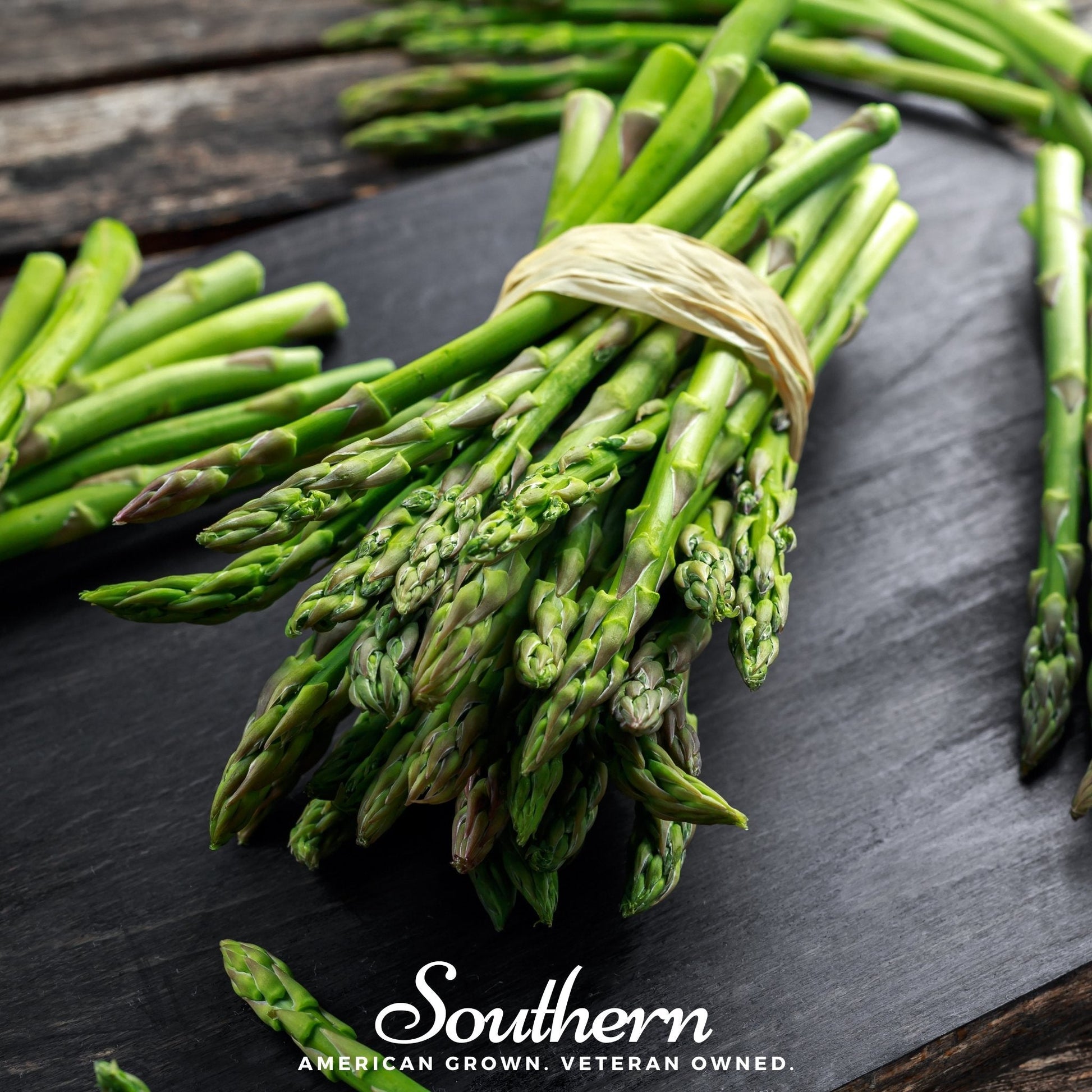 Bundled green asparagus on a dark surface with 'Southern' branding.