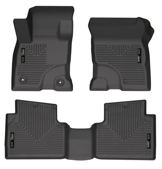 Set of four black car floor mats on a white background