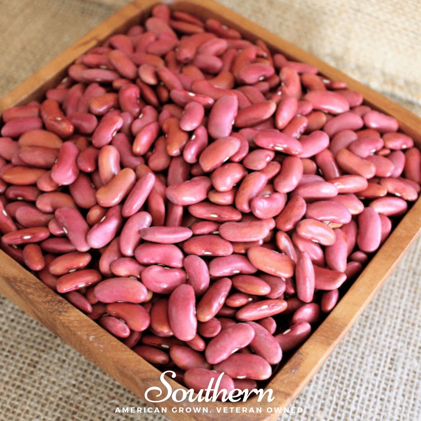 Red beans in a wooden bowl with 'Southern' branding on a textured fabric background