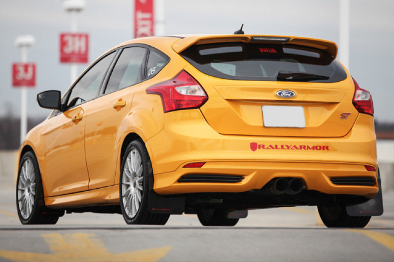 Yellow Ford Focus ST with Rally Armor logo on a blurred background