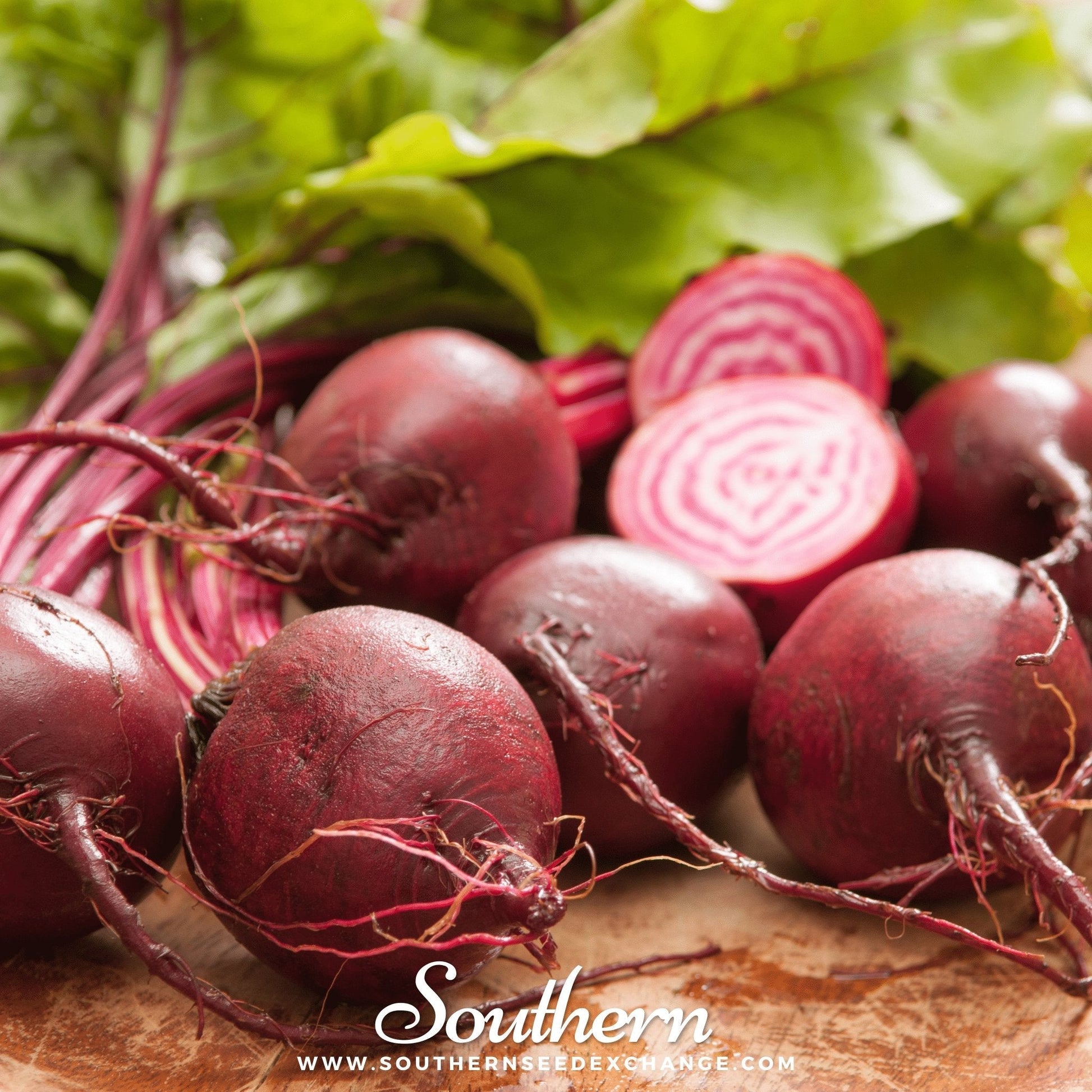 Close-up of fresh beets with green leaves on a wooden surface, branded 'Southern'.