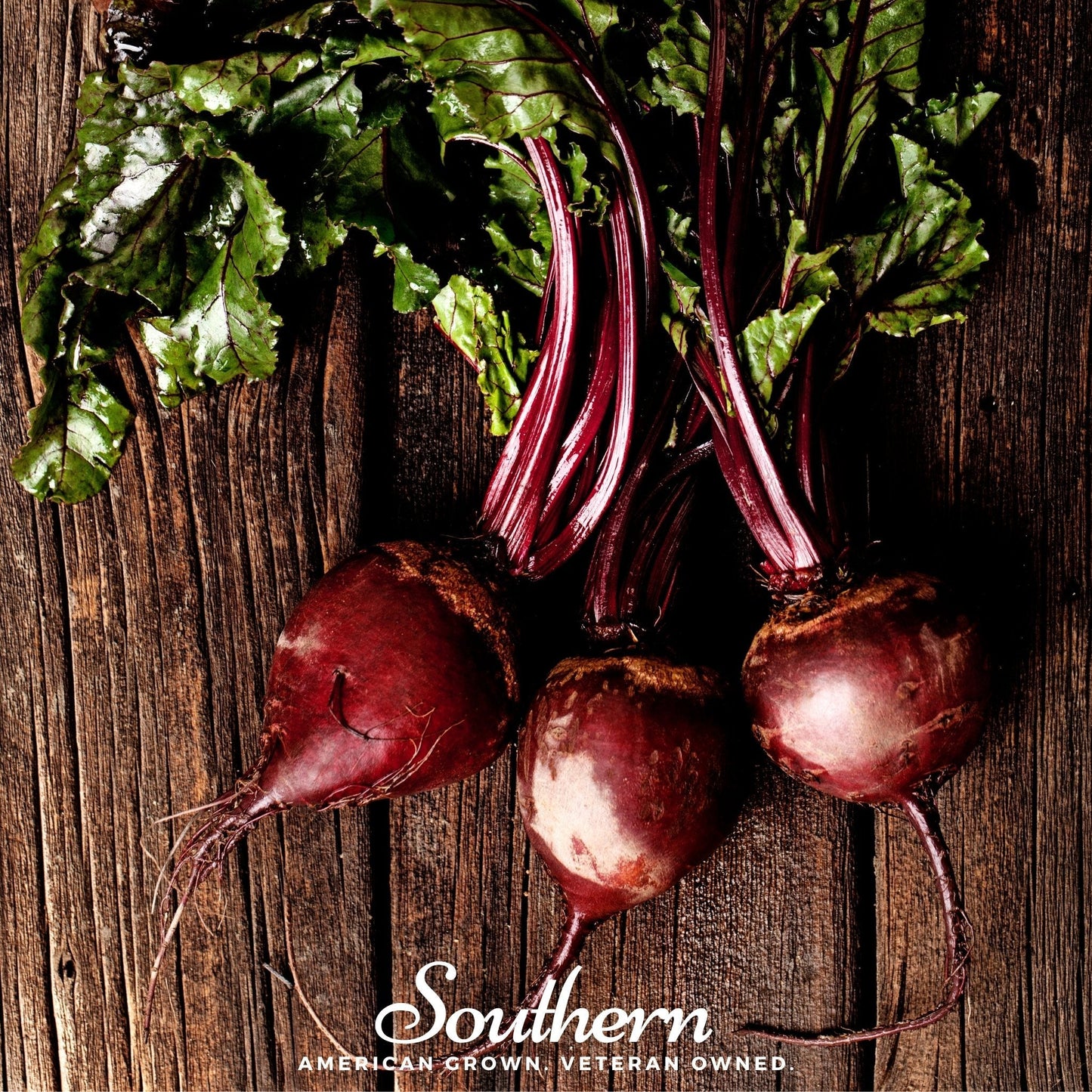 Three beets with green leaves on a wooden surface, branded 'Southern'.